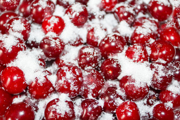 Ripe cherries are covered with sugar for canning. Juicy, bright background.