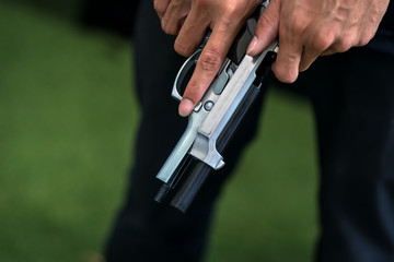 A man holding a gun in hand, the ship ready to shoot for self defense, Criminal concept.