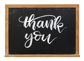 Thank you hand written in white chalk calligraphy lettering on a black chalkboard isolated on white