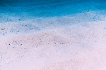 Water with sand is underwater. Sea texture in ocean.