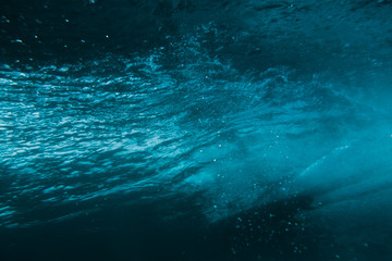 Fototapeta na wymiar Underwater barrel wave and surfer in tropical sea in Oahu.