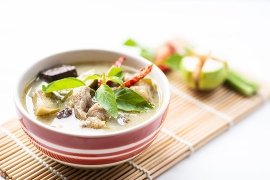 Green curry chicken (Kang Keaw Wan Gai) in a bowl with ingredients, Thai food