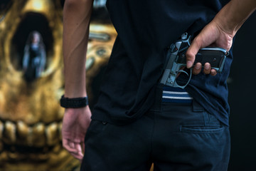 A man holding a gun in hand, the ship ready to shoot for self defense, Criminal concept.