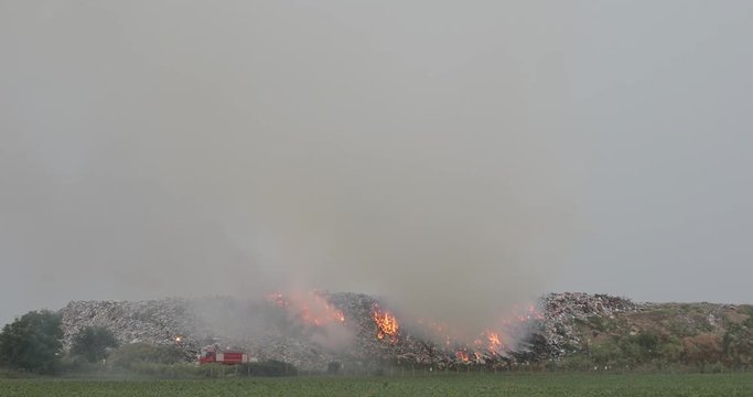 Firefighters at Garbage Dump Landfill Fire With Heavy Smoke Pollution