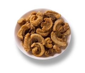 Pile of fried bacon cube portion in a white plate isolated.