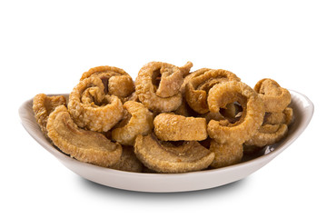 Pile of fried bacon cube portion in a white plate isolated.