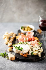 Cheese variety,  olives,  Prosciutto and wine