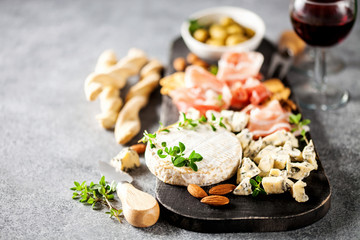 Cheese variety,  olives,  Prosciutto and wine