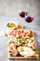 Cheese variety,  olives,  Prosciutto and wine