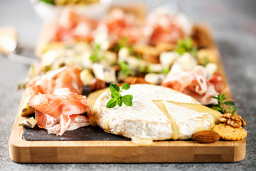 Cheese variety,  olives,  Prosciutto and wine