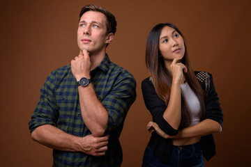 Young couple thinking and looking up