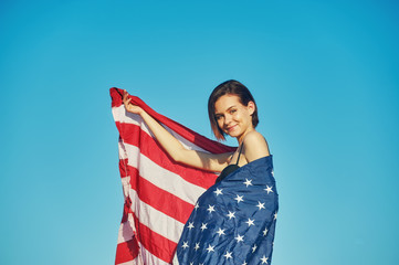 A young woman holding the us flag