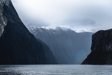 Fototapeta na wymiar A stunning scene of nature with snow mountain and waterfalls at Milford Sound, New Zealand.