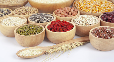 Cereal grains , seeds, beans on wooden background