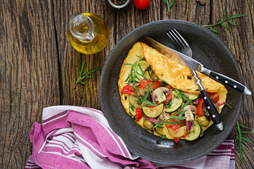 Omelet with tomatoes, zucchini and mushrooms. Omelette breakfast. Healthy food. Top view. Flat lay