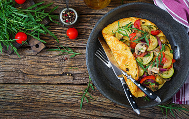 Omelet with tomatoes, zucchini and mushrooms. Omelette breakfast. Healthy food. Top view. Flat lay
