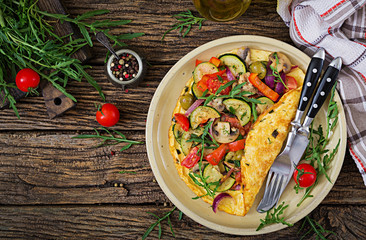 Omelet with tomatoes, zucchini and mushrooms. Omelette breakfast. Healthy food. Top view. Flat lay