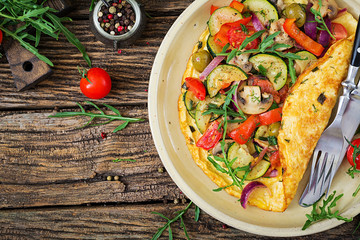 Omelet with tomatoes, zucchini and mushrooms. Omelette breakfast. Healthy food. Top view. Flat lay