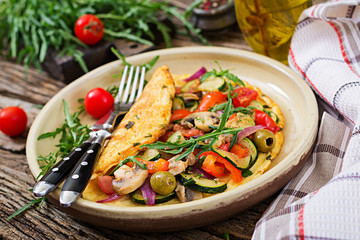 Omelet with tomatoes, zucchini and mushrooms. Omelette breakfast. Healthy food.
