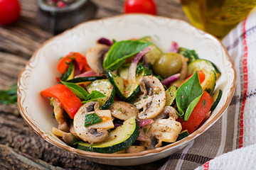 Saute with mushrooms, zucchini, tomatoes, onions and olives. Vegetable stew. Vegetarian, vegan food. Healthy meal.
