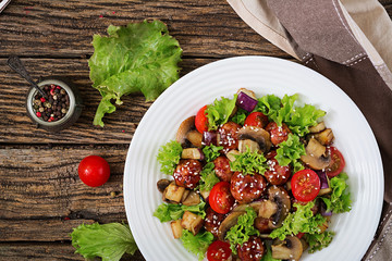Salad with meatballs, eggplant, mushrooms and tomatoes in Asian style. Healthy food. Diet meal. Top view. Flat lay.