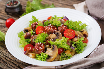 Salad with meatballs, eggplant, mushrooms and tomatoes in Asian style. Healthy food. Diet meal.