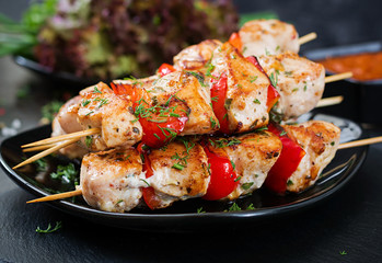 Chicken skewers with slices of sweet peppers and dill. Tasty food. Weekend meal.