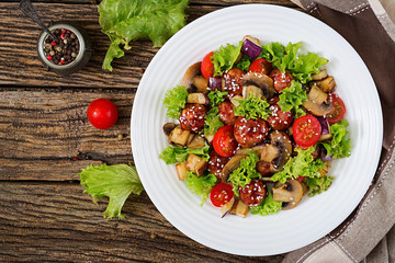 Salad with meatballs, eggplant, mushrooms and tomatoes in Asian style. Healthy food. Diet meal. Top view. Flat lay.