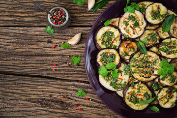 Eggplant grilled with balsamic sauce, garlic, cilantro and mint. Vegan food. Grilled aubergine. Top view. Flat lay