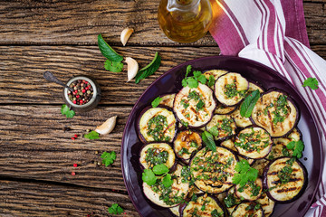 Eggplant grilled with balsamic sauce, garlic, cilantro and mint. Vegan food. Grilled aubergine. Top view. Flat lay