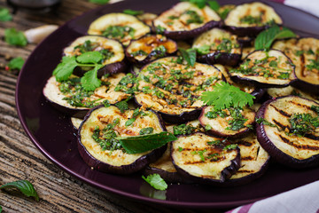 Eggplant grilled with balsamic sauce, garlic, cilantro and mint. Vegan food. Grilled aubergine.