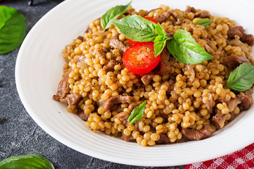 Israeli couscous with beef. Tasty food. Asian meal.