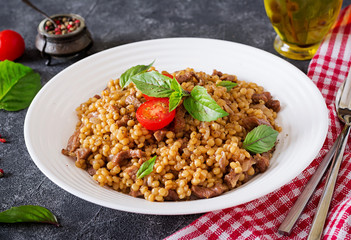 Israeli couscous with beef. Tasty food. Asian meal.