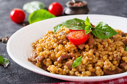 Israeli couscous with beef. Tasty food. Asian meal.