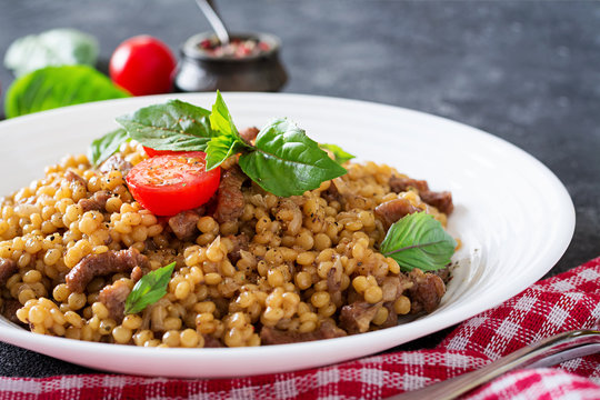Israeli couscous with beef. Tasty food. Asian meal.