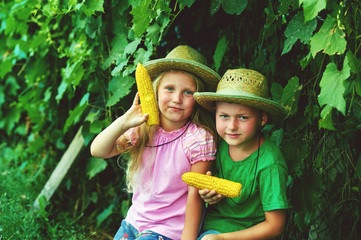 Funny children in nature holding boiled corn © fisher05