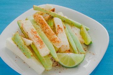 pepinos y jicama con chile, mexican snack, cucumber and jicamas with chili, spicy food in mexico