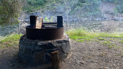 River side fire pit with logs - 210389416