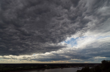 A huge cloud covered half the sky. Summer landscape.