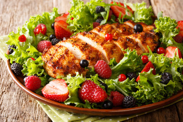 Colorful salad of grilled chicken with summer berries and herbs closeup. Dietary food. horizontal