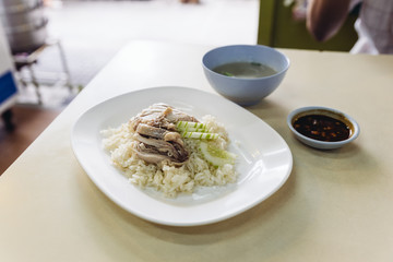 Hainanese chicken rice, Thai gourmet steamed chicken with rice served with sliced of cucumber and soup.