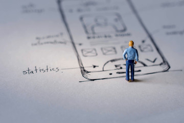 User Experience Concept. present by Miniature Figure of UX UI Designer standing on Paper of...