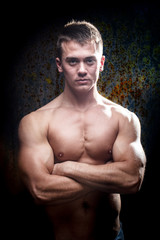 Fototapeta premium Portrait of a shirtless muscular young man