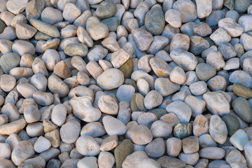 Grey big gravel on a beach