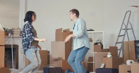 Pretty woman and a young man are dancing for joy