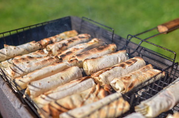 Pita bread filled with cheese and vegetables, grilled on fire