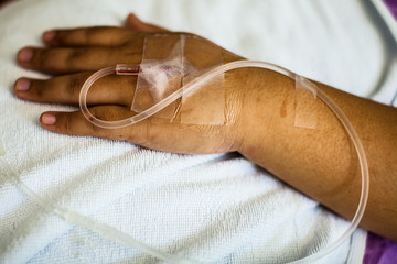 Patient hand with saline solution in the hospital.