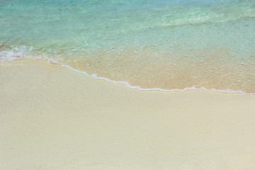 Fototapeta na wymiar Blue ocean wave on sandy beach