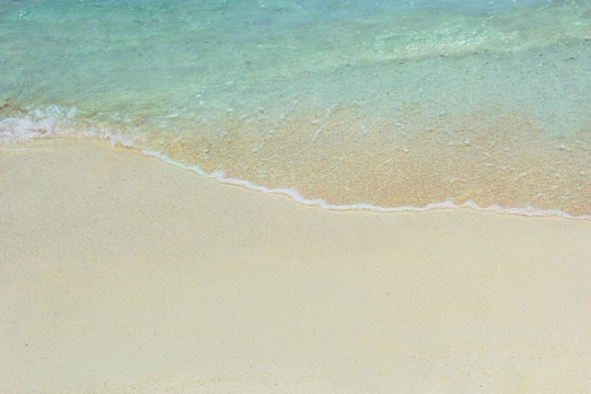 Blue ocean wave on sandy beach