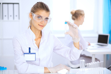 Fototapeta premium Female scientific researcher or blood test assistant in laboratory. Medicine concept